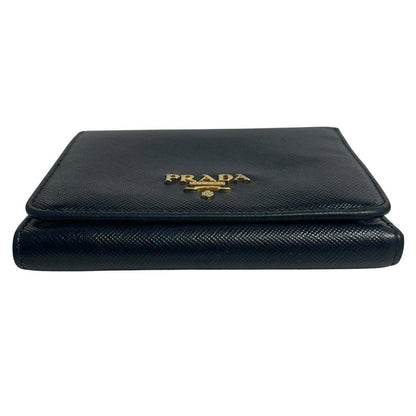 Prada black bifold wallet Saffiano leather with logo embossed detail.