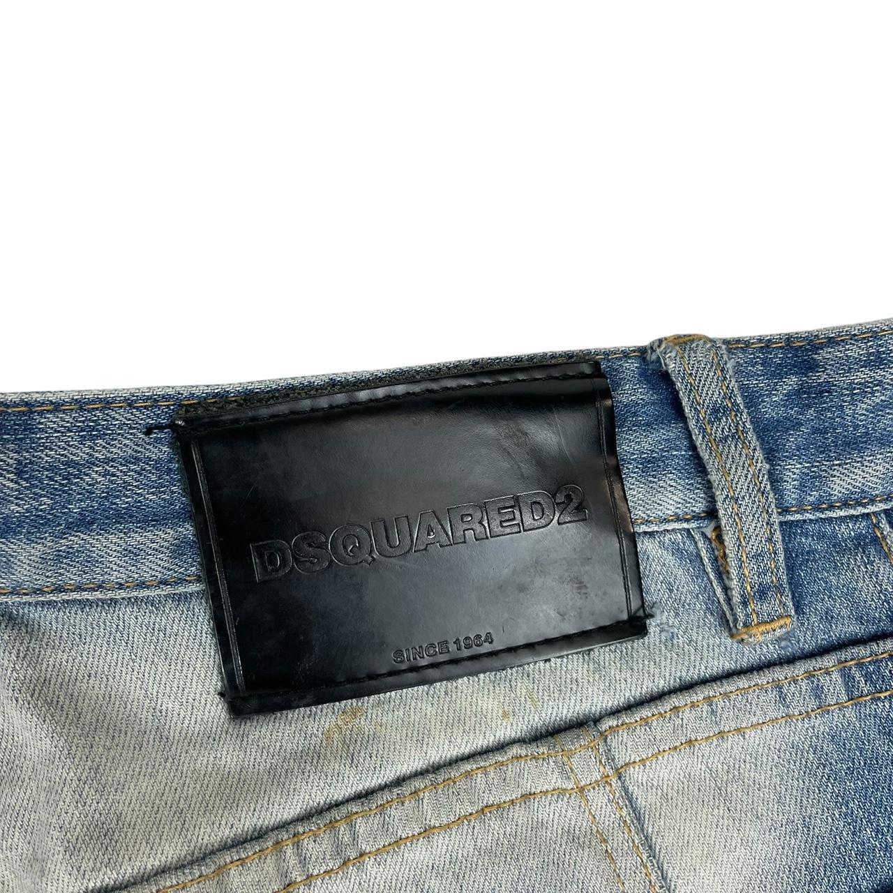 Dsquared2 blue straight jeans with distressed details and logo patch on back pocket.