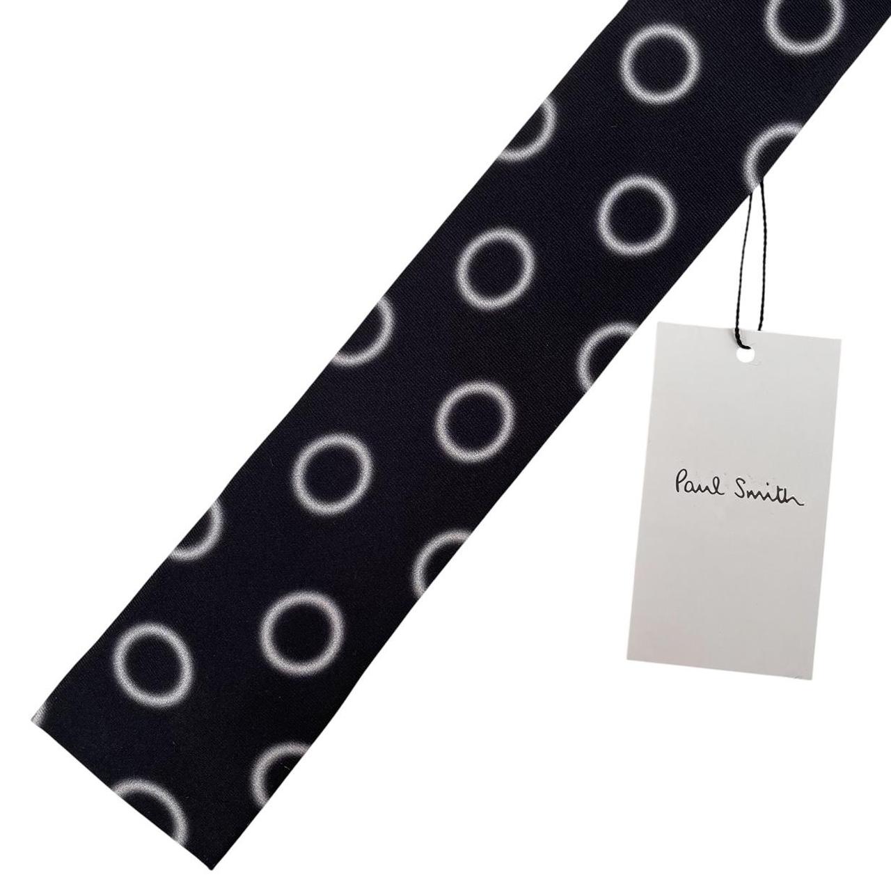 Paul Smith black and white silk tie with circular print and square cut design.