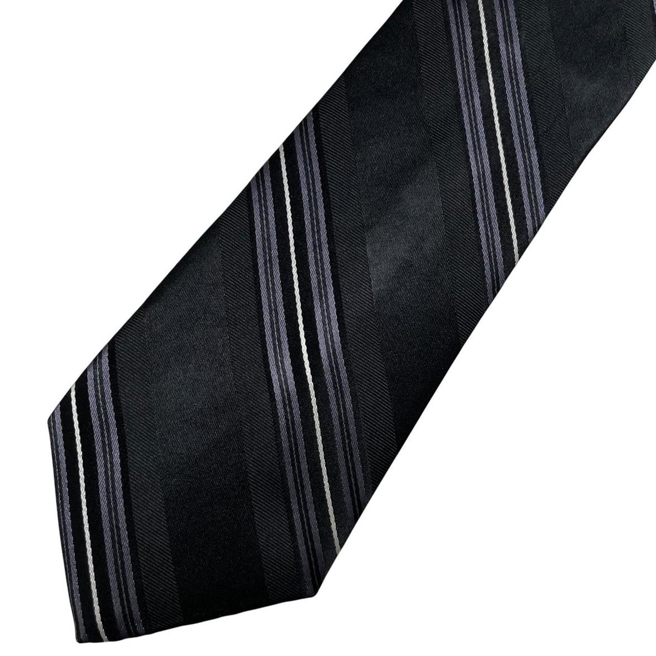 DKNY black silk tie with vintage striped pattern and logo detail.