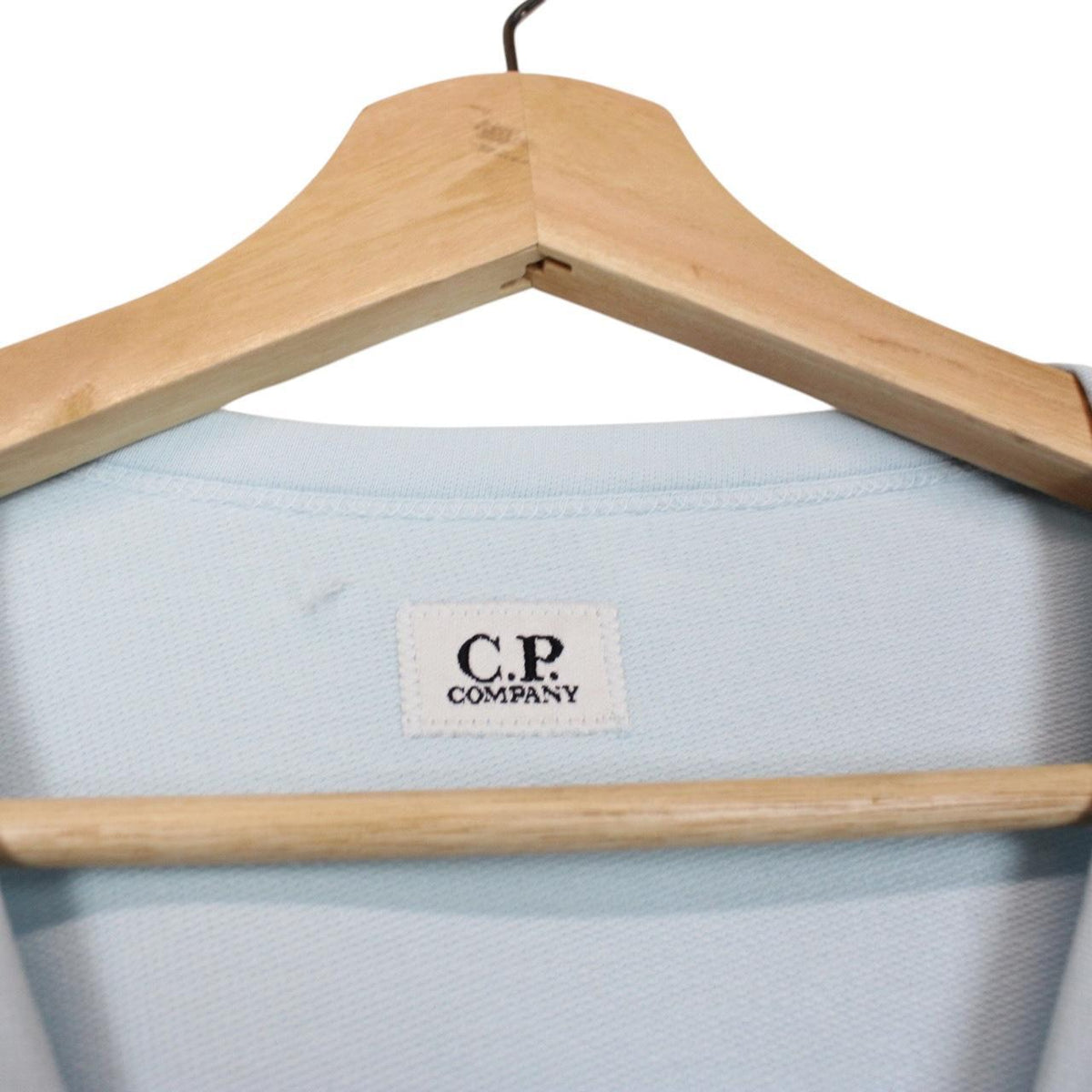 CP Company light blue sweatshirt with signature lens detail and cotton fabric.