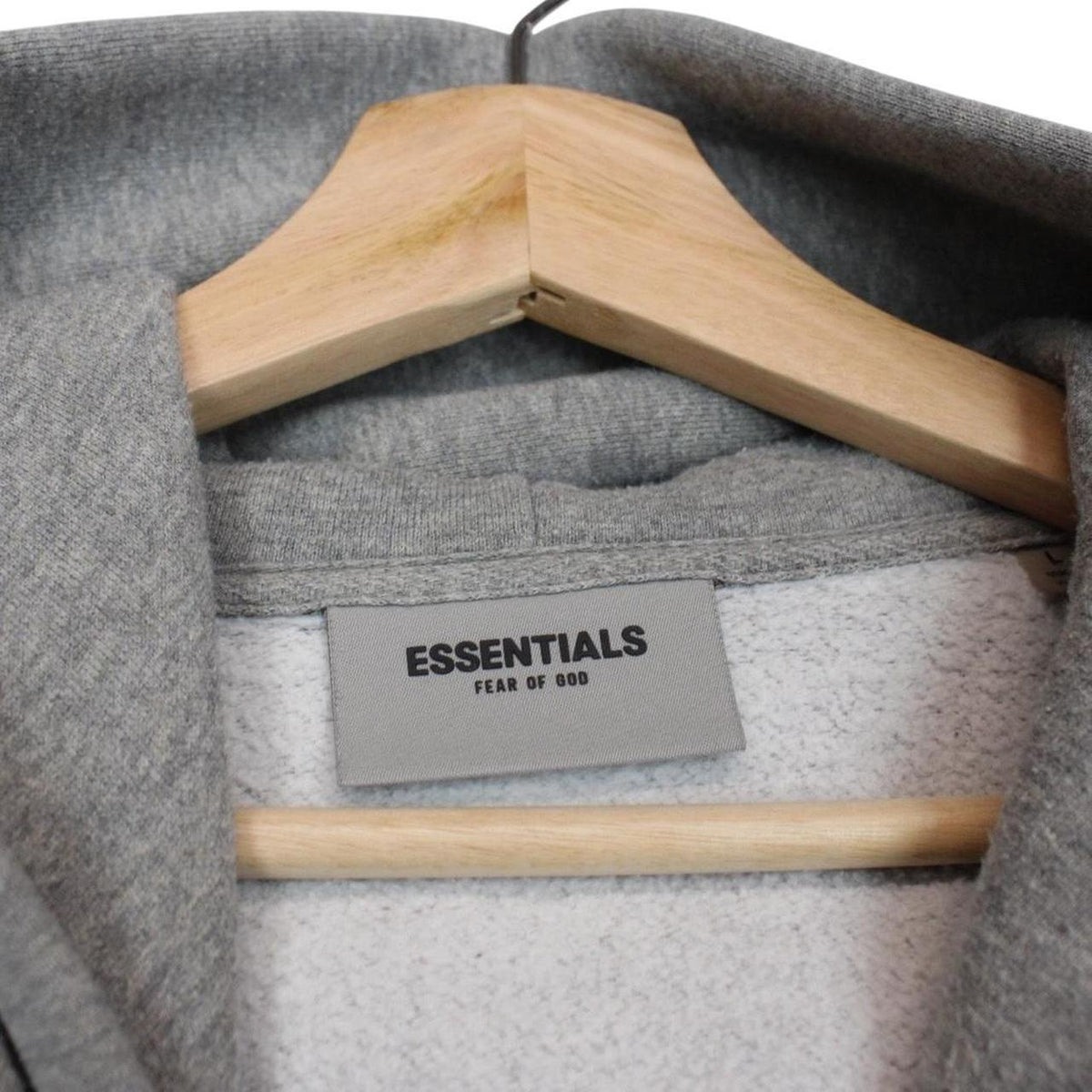 Essentials grey hoodie jumper with oversized fit and subtle logo detail.