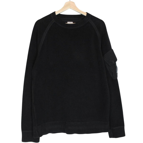 CP Company black fleece jumper with raglan sleeves and iconic lens detail.