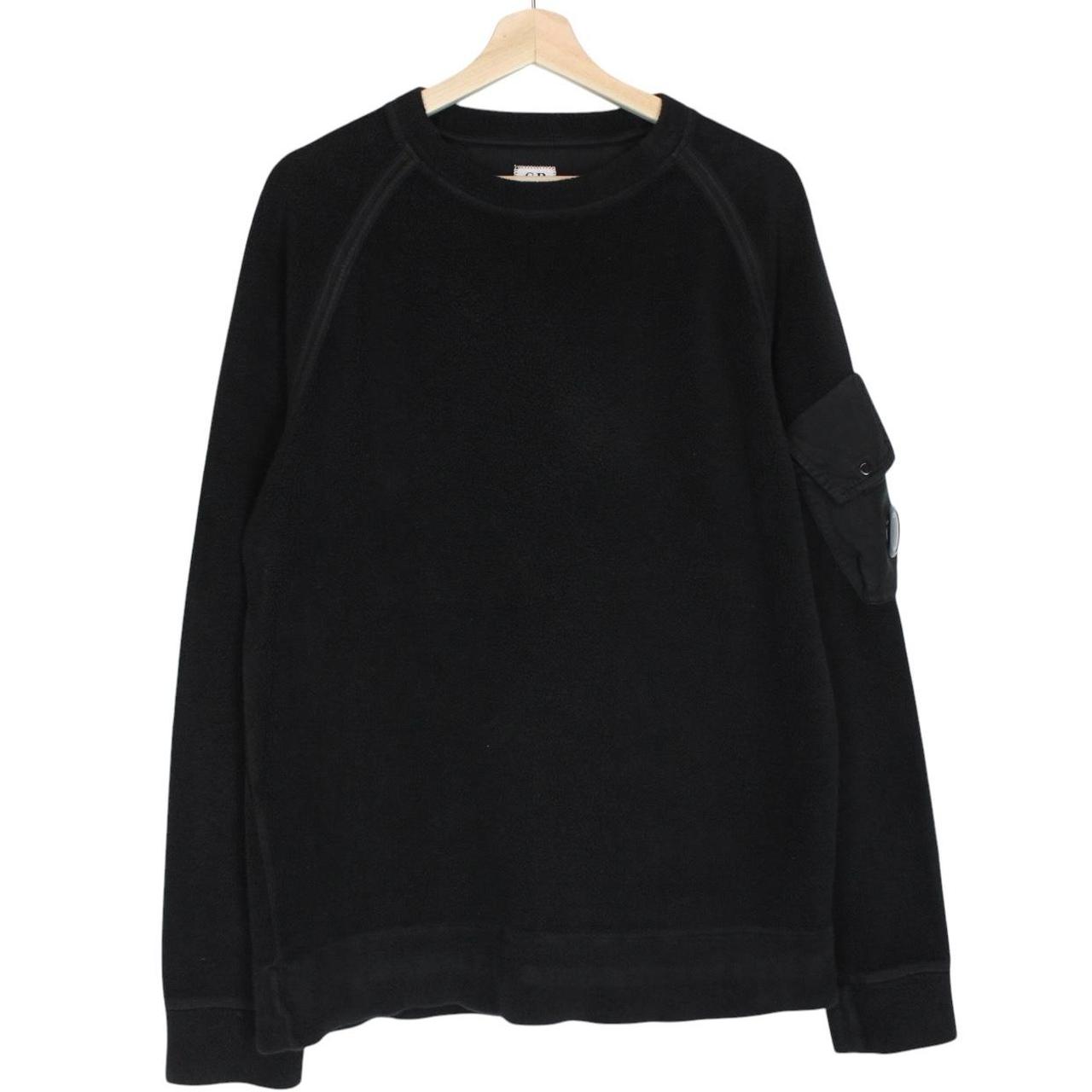 CP Company black fleece jumper with raglan sleeves and iconic lens detail.