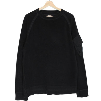 CP Company black fleece jumper with raglan sleeves and iconic lens detail.