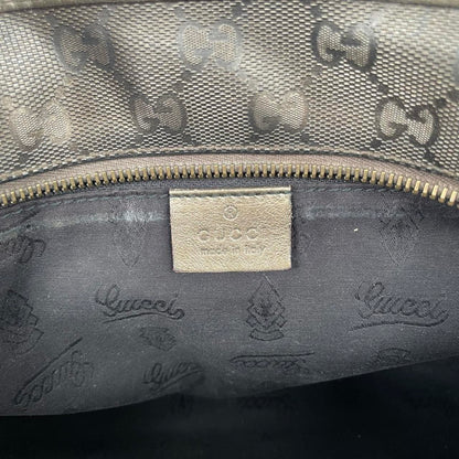 Gucci khaki green duffel bag with metallic monogram canvas and leather trim details.