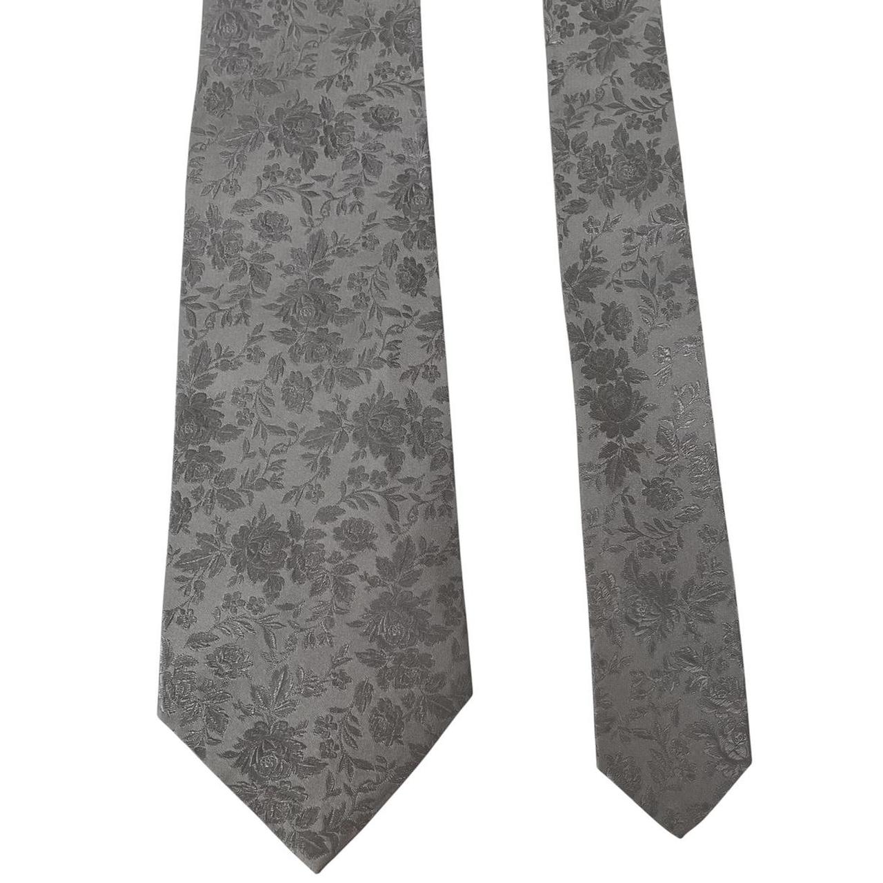 Paul Smith silver silk tie with floral print and brand logo detail.
