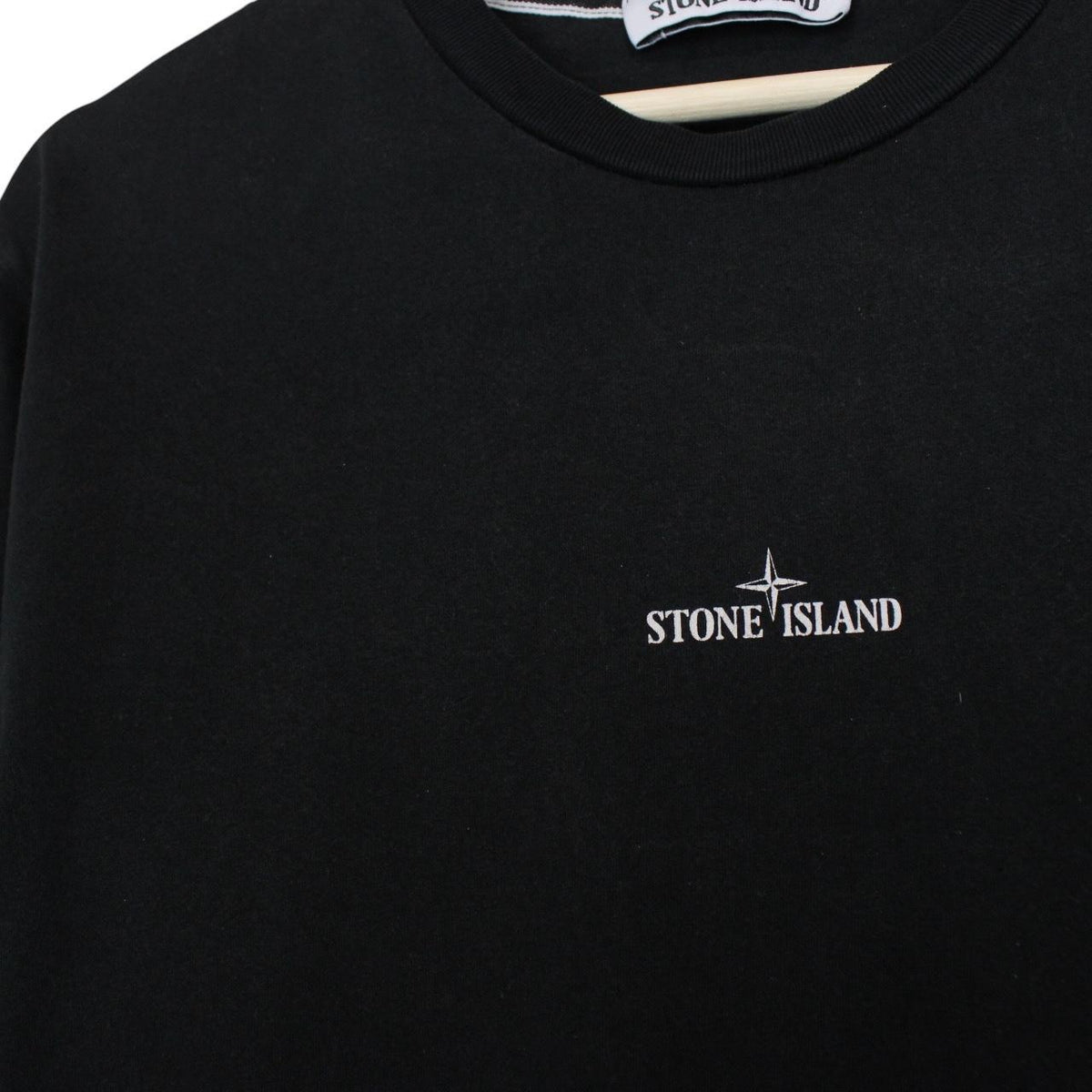 Stone Island black short sleeve t-shirt with logo print on chest and cotton material.
