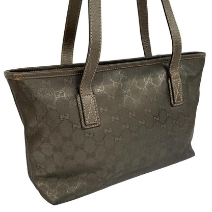 Gucci khaki green duffel bag with metallic monogram canvas and leather trim details.