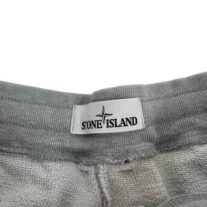 Stone Island grey tracksuit bottoms cotton material with logo patch and faint marks.