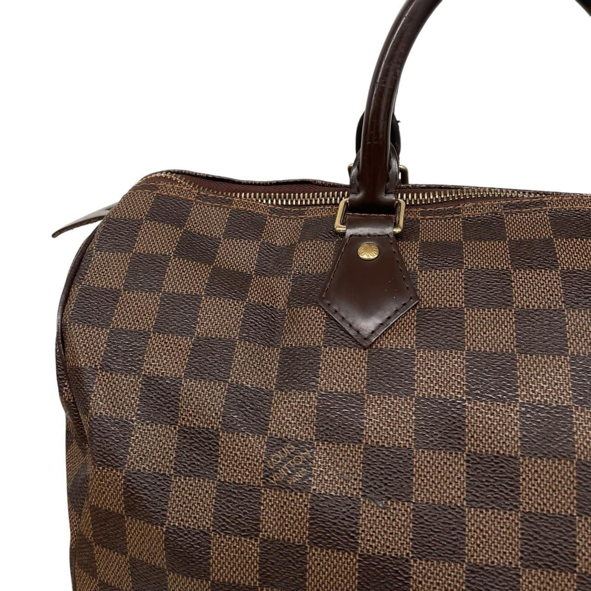 Louis Vuitton brown Damier Ebene canvas Speedy 35 bag with logo and gold-tone hardware.