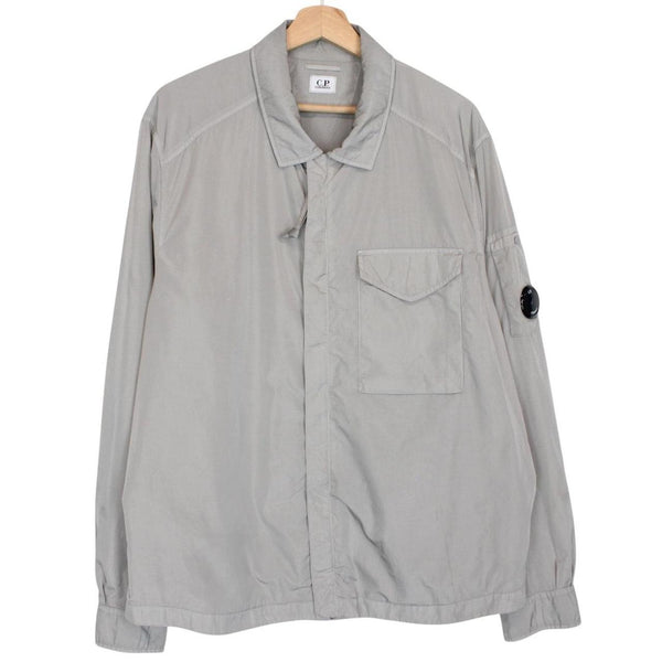 CP Company grey overshirt jacket with lens detail and garment dyed nylon fabric.