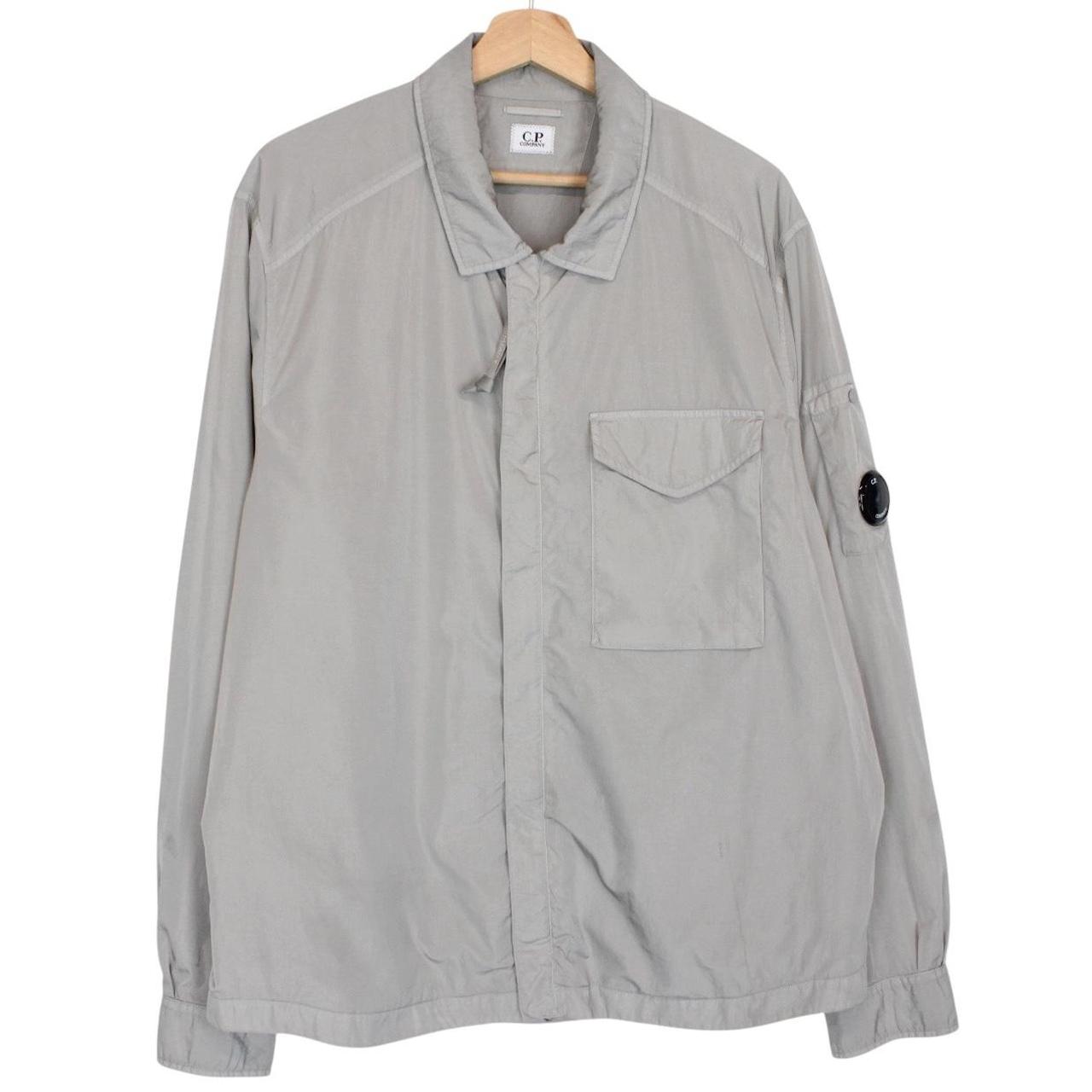 CP Company grey overshirt jacket with lens detail and garment dyed nylon fabric.