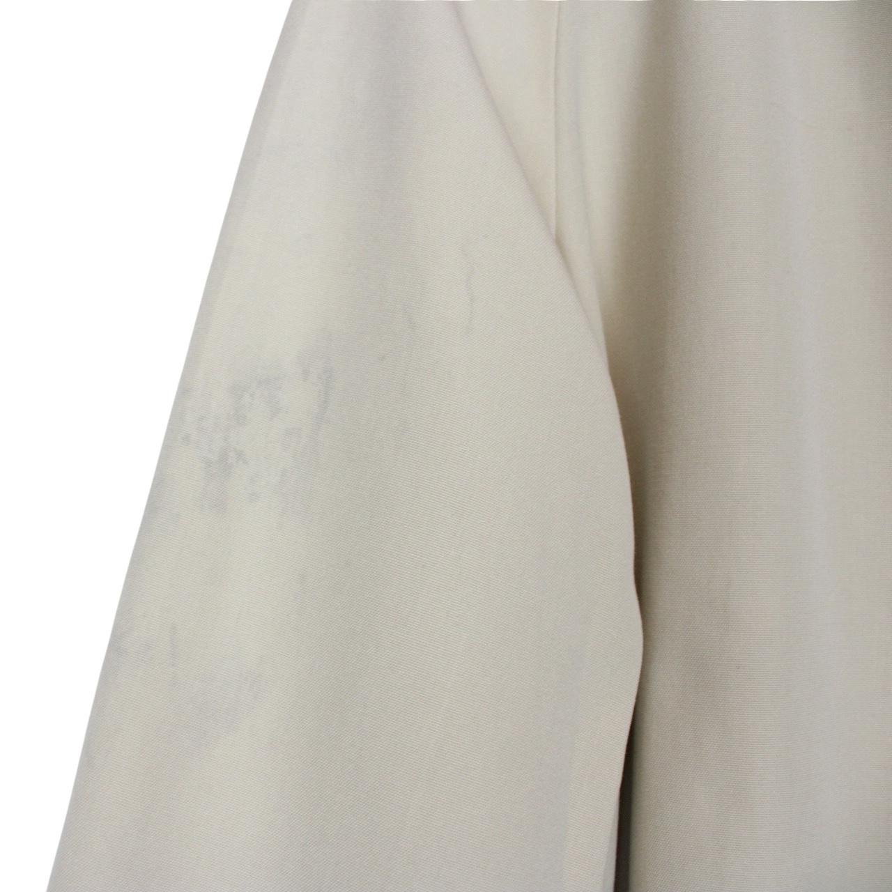 Burberry cream trench coat, single breasted, vintage 80s style, visible mark on sleeve.