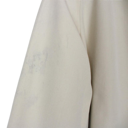 Burberry cream trench coat, single breasted, vintage 80s style, visible mark on sleeve.