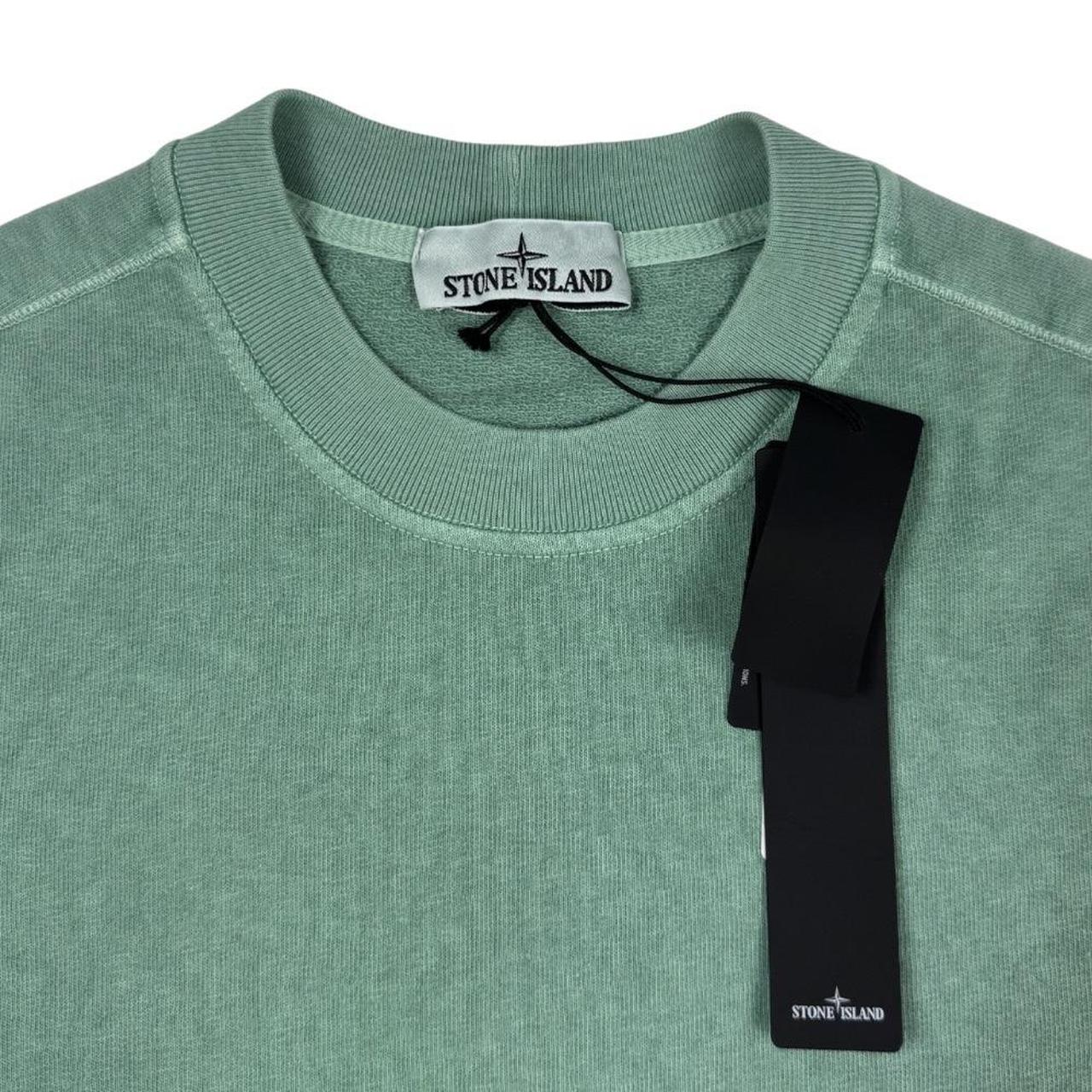 Stone Island green sweatshirt with logo patch and garment dyed cotton material.
