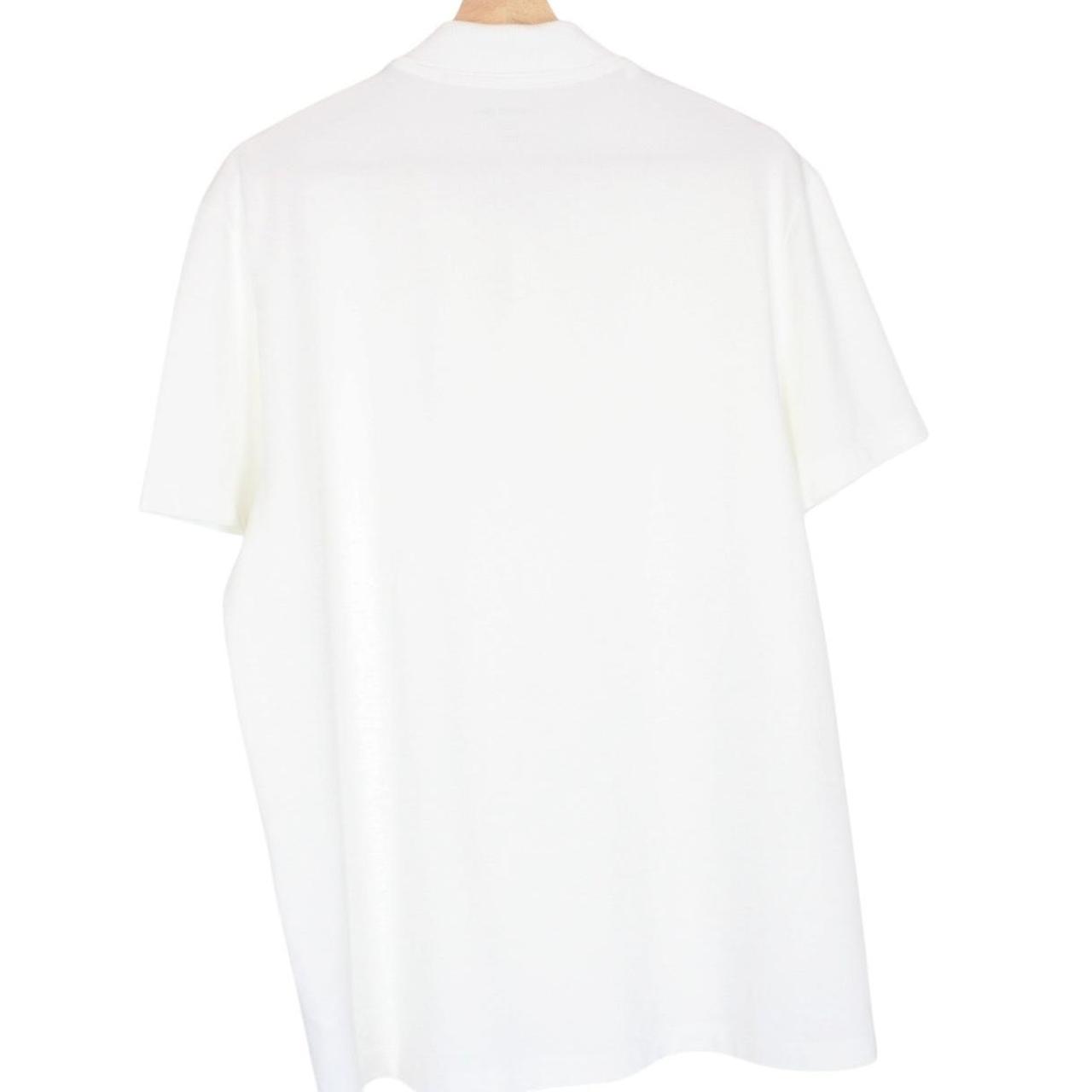 Lacoste white short sleeve polo shirt with green crocodile logo and cotton material.