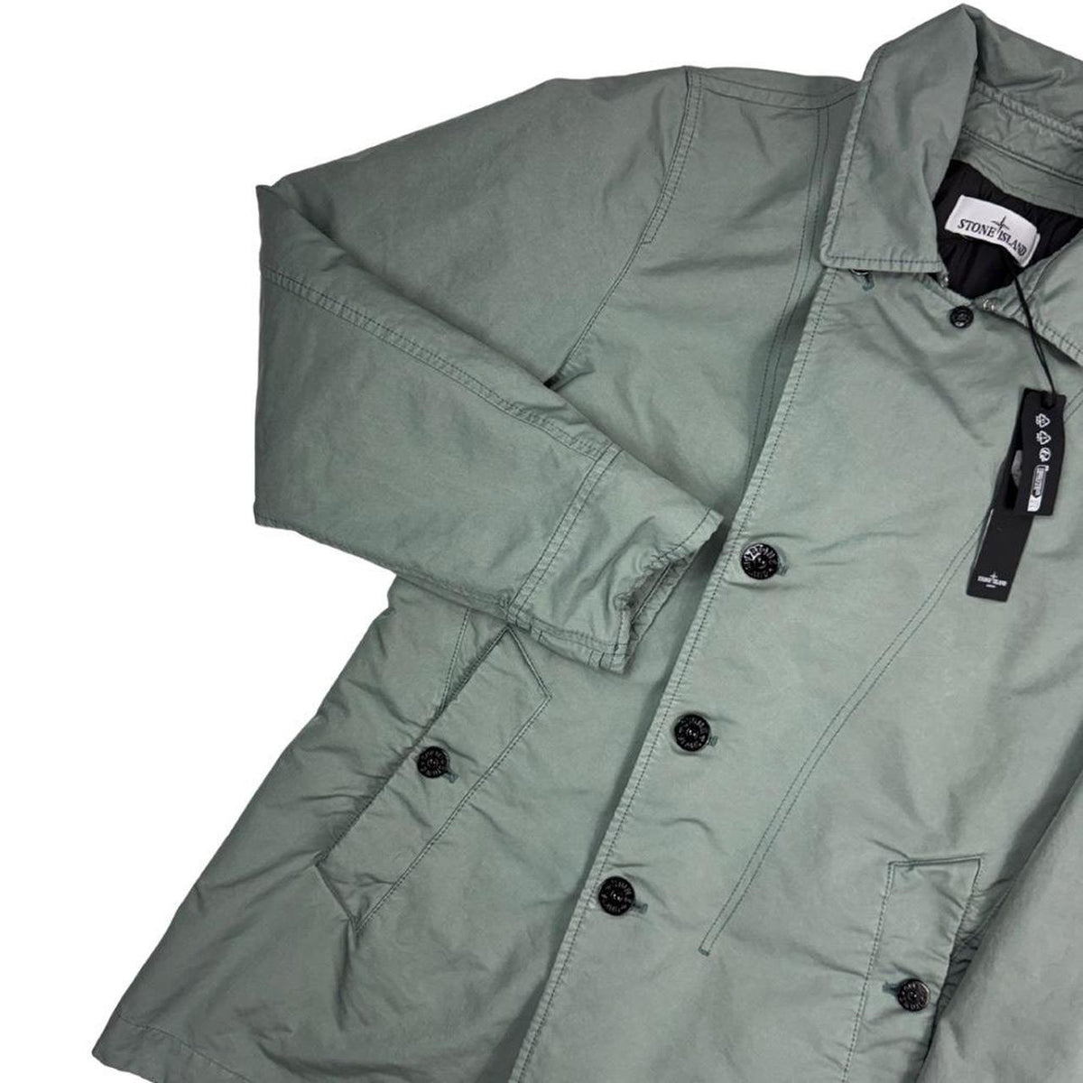 Stone Island green jacket with Primaloft insulation and iconic compass logo.