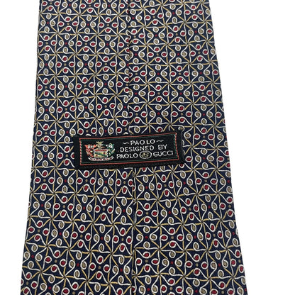 Gucci navy blue silk tie with vintage pattern and logo detail.