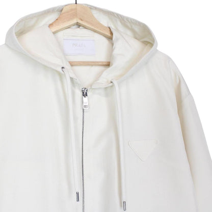 Prada cream silk hooded jacket with triangle logo and full zip detail.