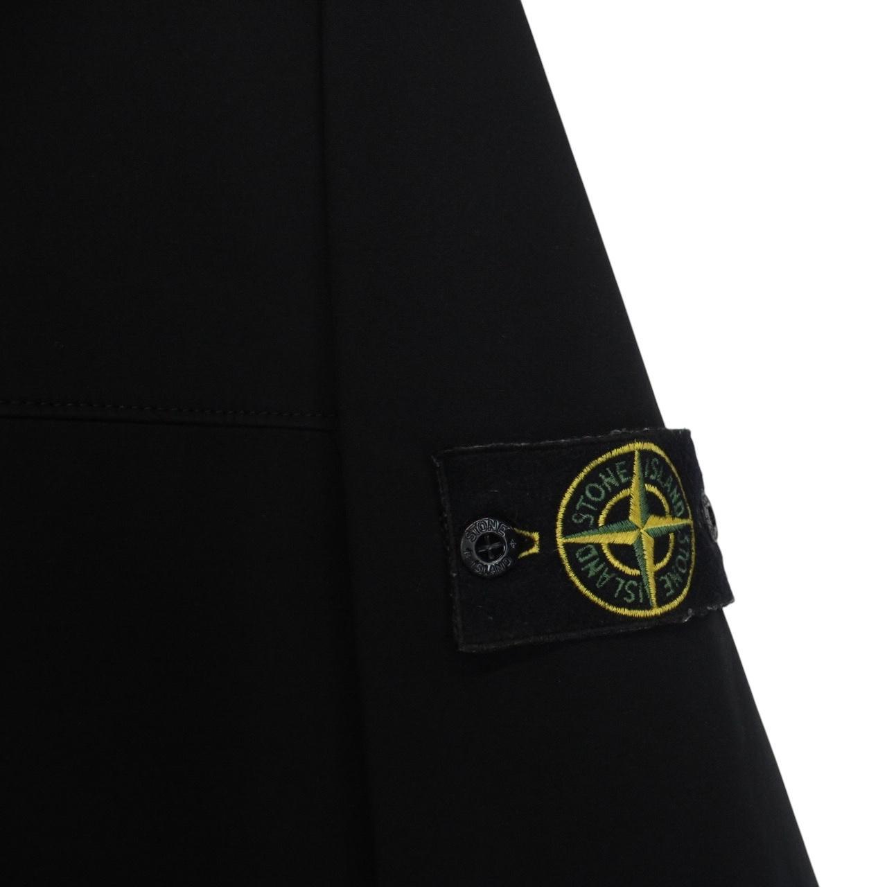 Stone Island black soft shell jacket with full zip and iconic compass logo.