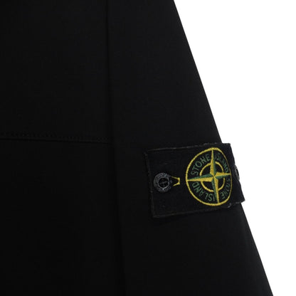 Stone Island black soft shell jacket with full zip and iconic compass logo.