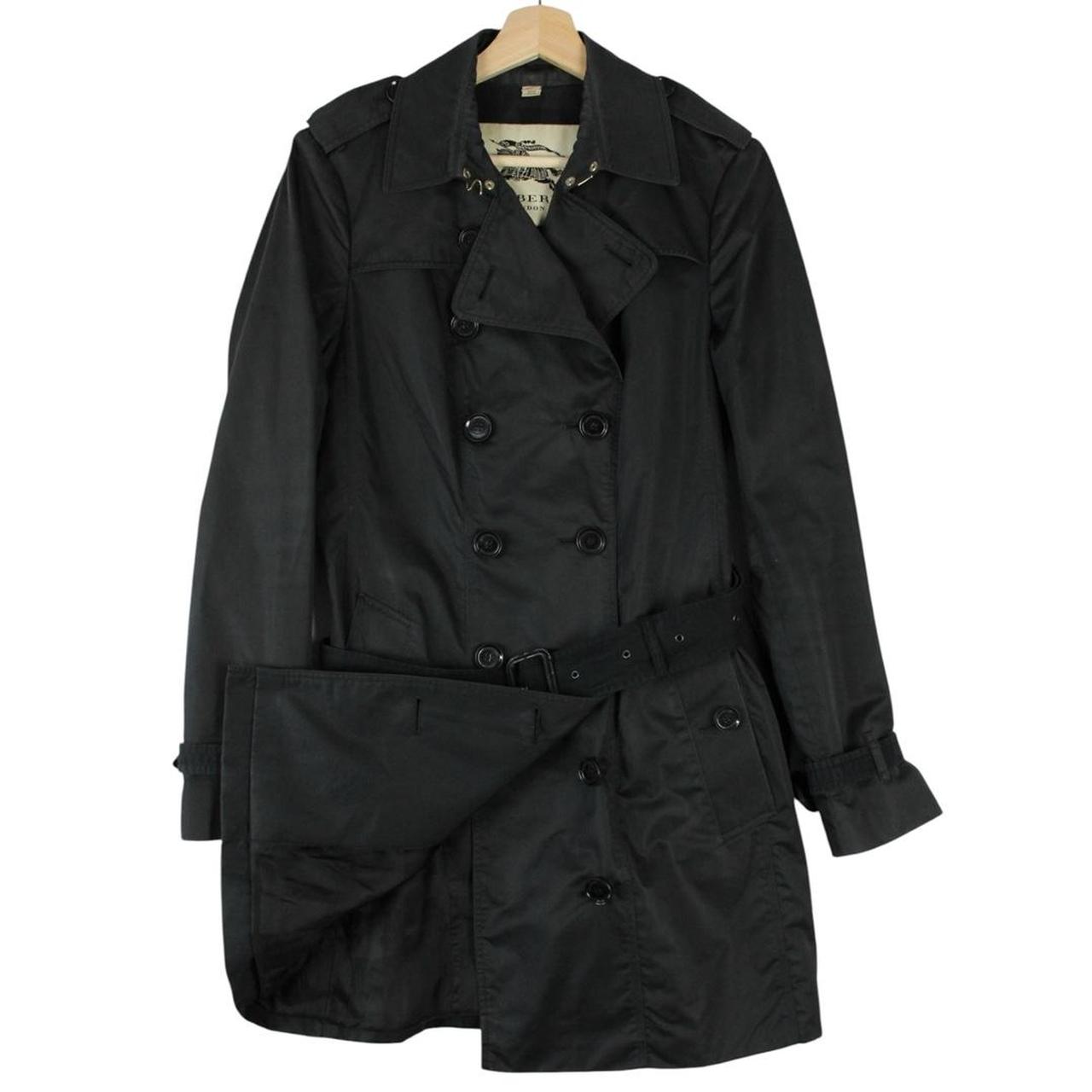 Burberry black double breasted belted trench coat with logo detailing and classic design.