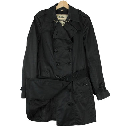 Burberry black double breasted belted trench coat with logo detailing and classic design.