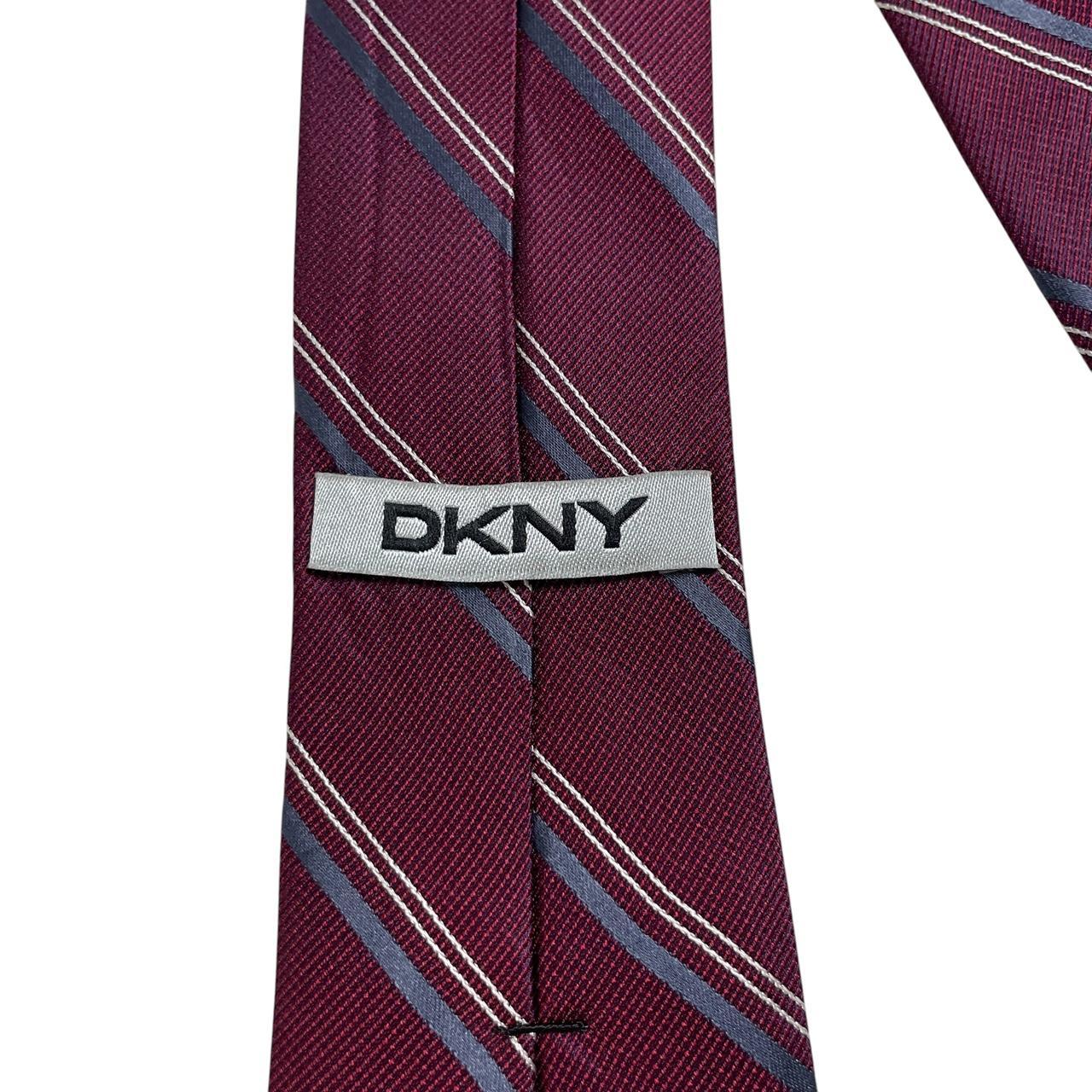 DKNY plum purple silk tie with a smooth finish and vintage design.
