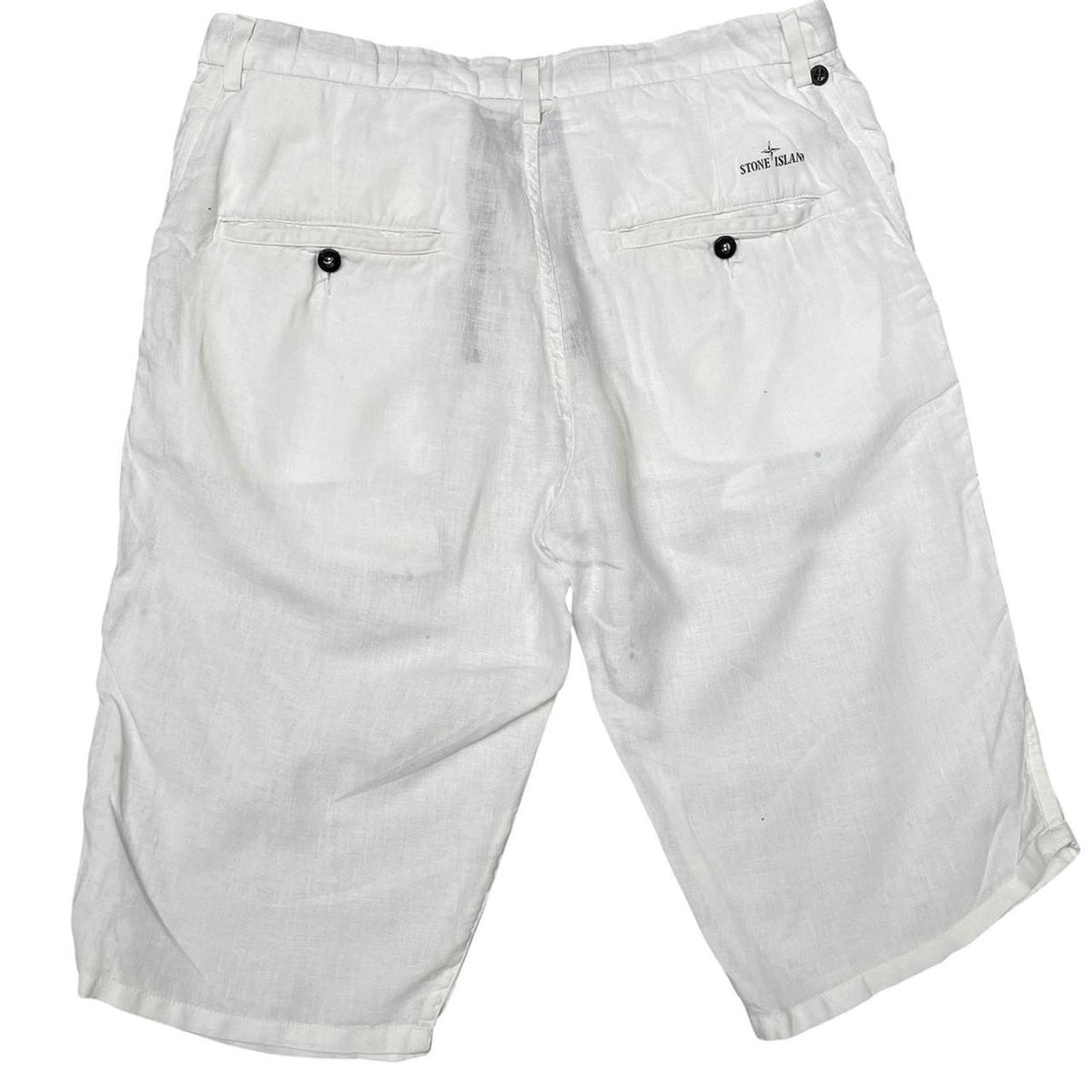 Stone Island white linen Bermuda shorts with logo patch and subtle stains.