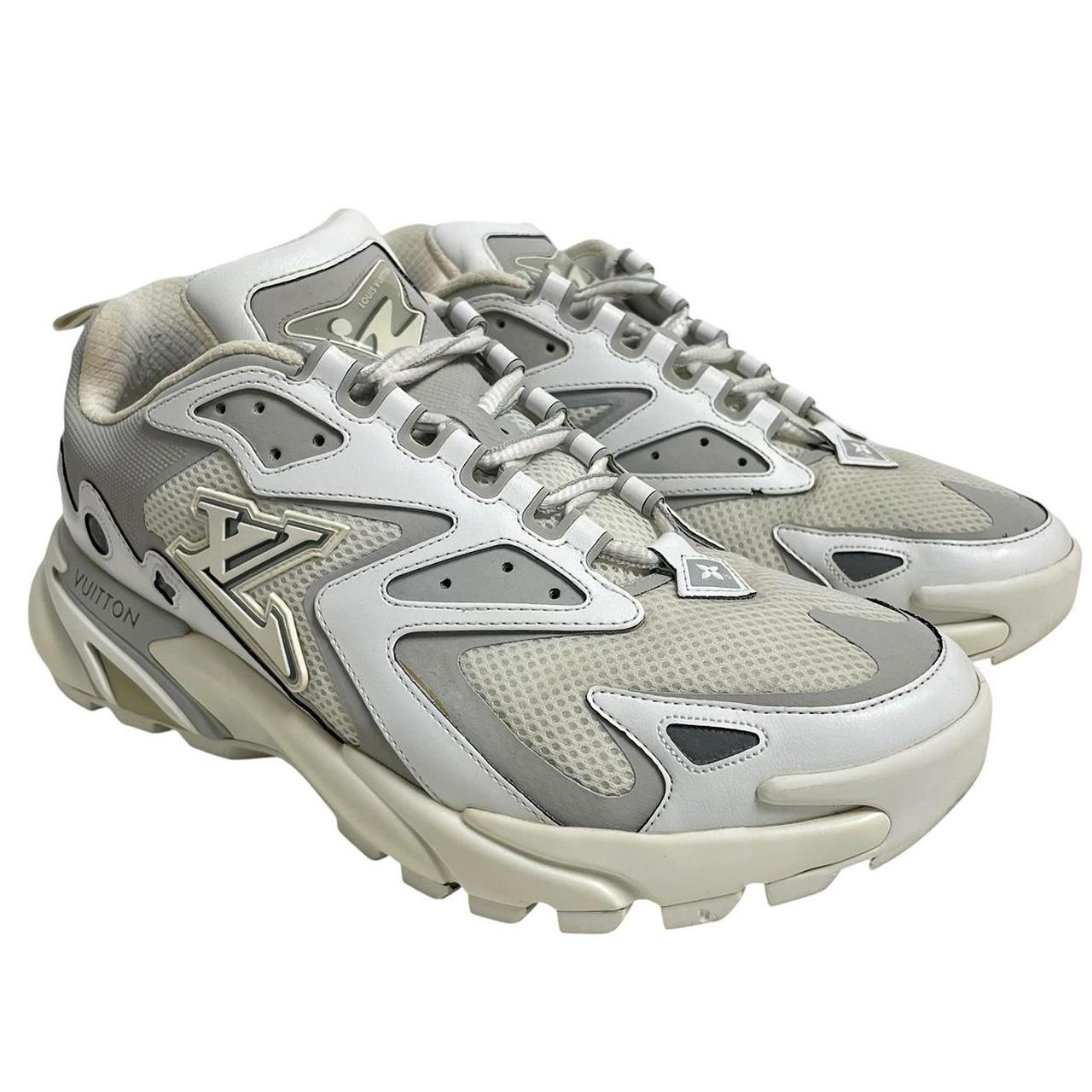 Louis Vuitton white trainers with logo detailing and sleek design, pre-owned condition.