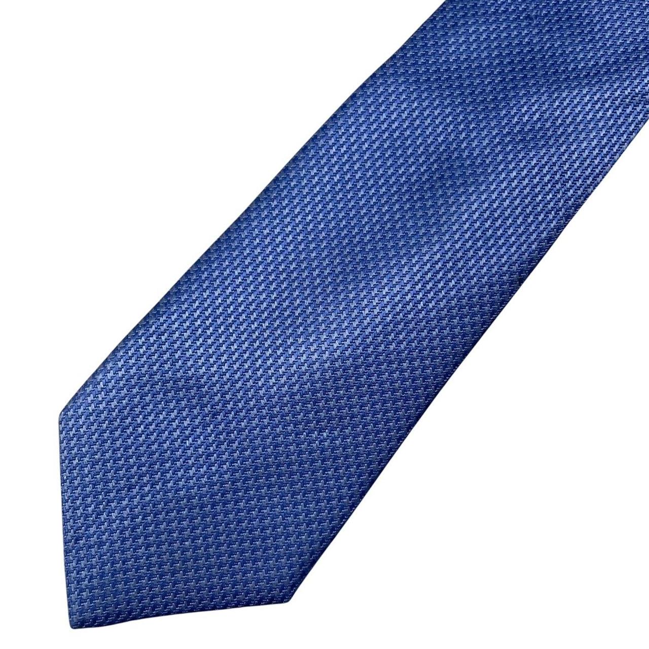 DKNY blue silk tie with subtle sheen and classic design.