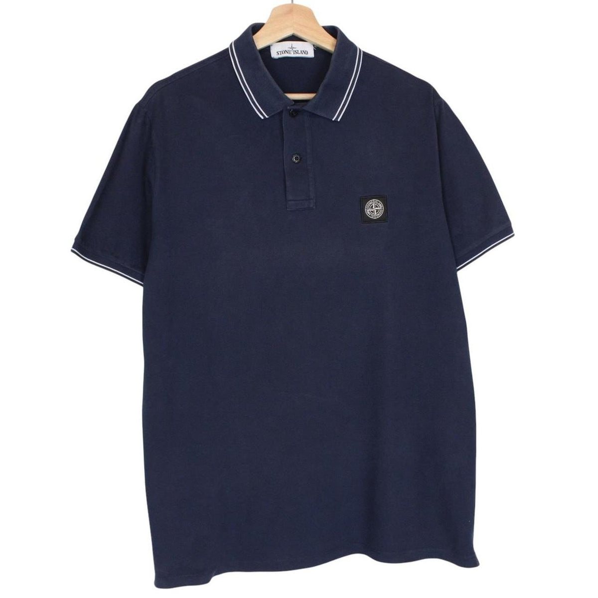 Stone Island navy blue polo shirt with embroidered compass logo and cotton material.