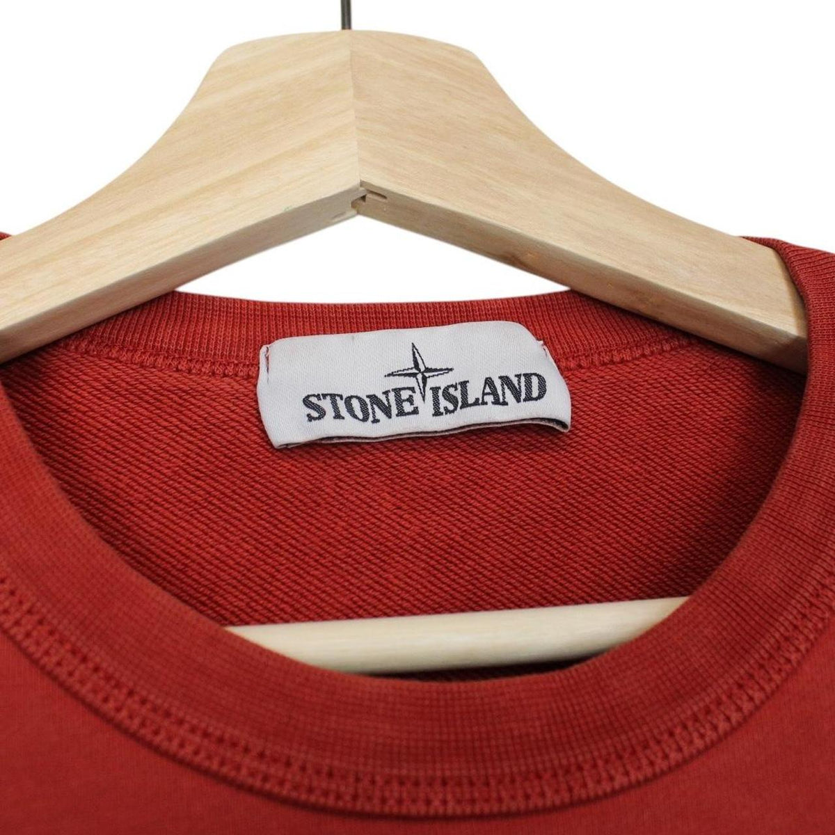 Stone Island red cotton sweatshirt with logo badge and ribbed cuffs.