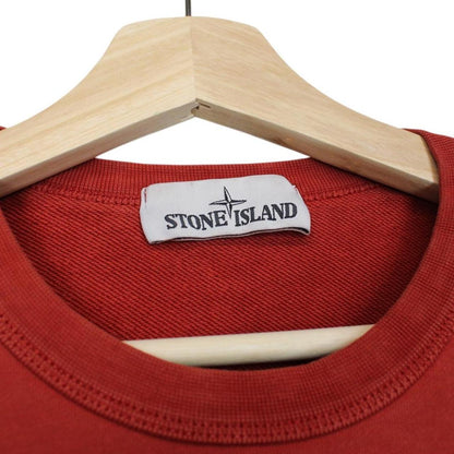 Stone Island red cotton sweatshirt with logo badge and ribbed cuffs.