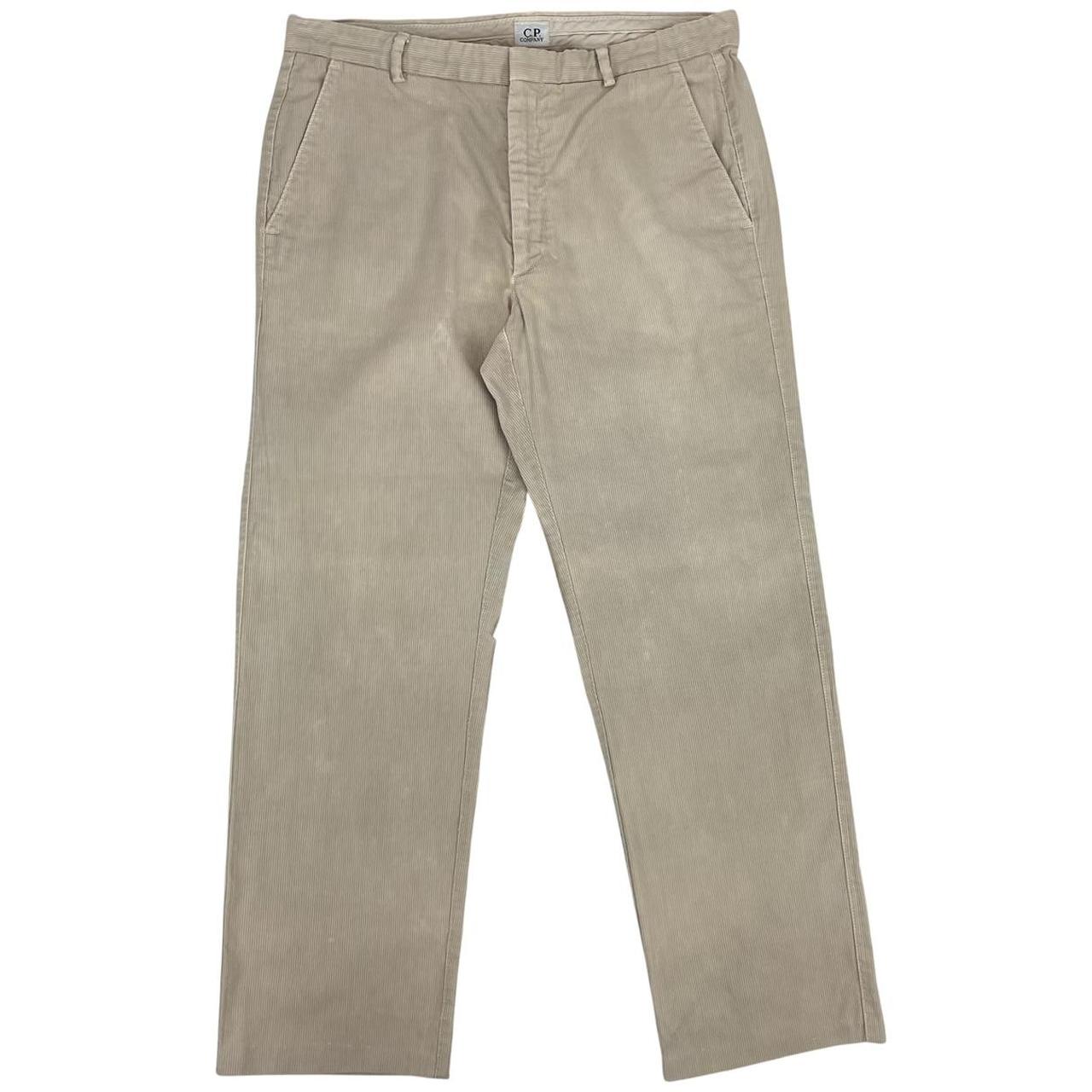 CP Company beige ribbed cotton trousers with faint stains and regular fit design.