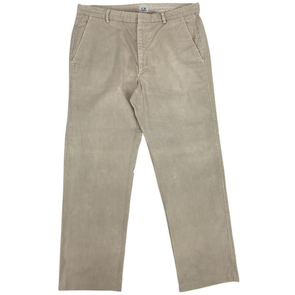 CP Company beige ribbed cotton trousers with faint stains and regular fit design.