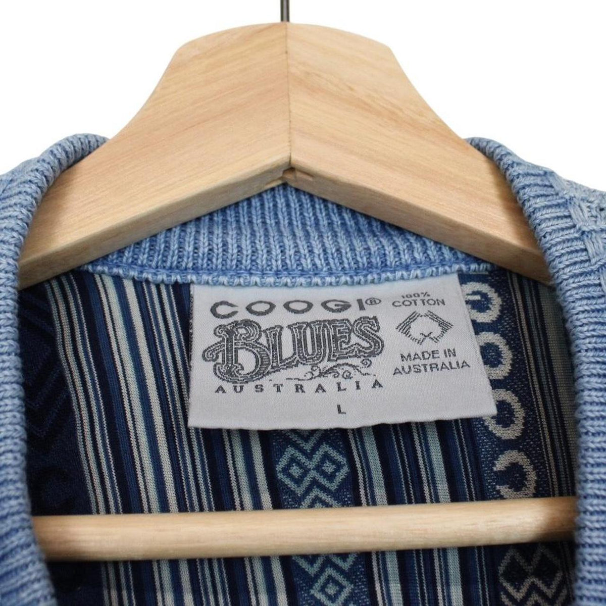 Coogi blue cotton knit full zip cardigan with signature colorful pattern and logo.