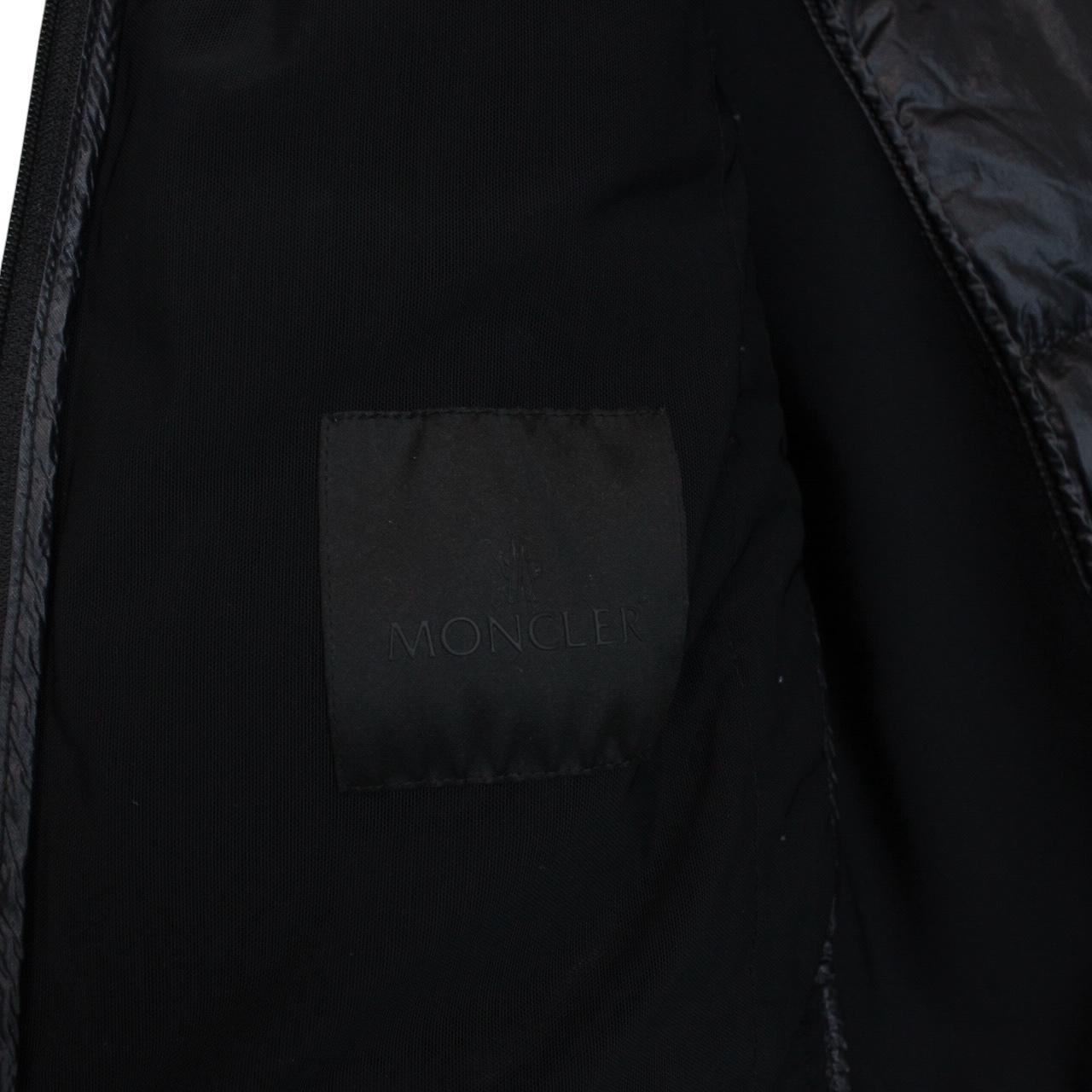 Moncler black lightweight down jacket with full zip and logo patch on sleeve.
