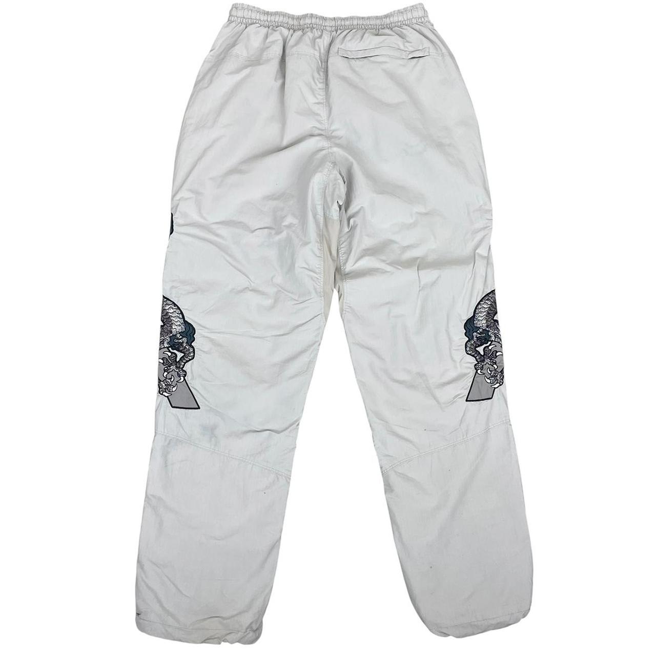 Palace grey joggers embroidered dragon design, made of nylon, size medium.