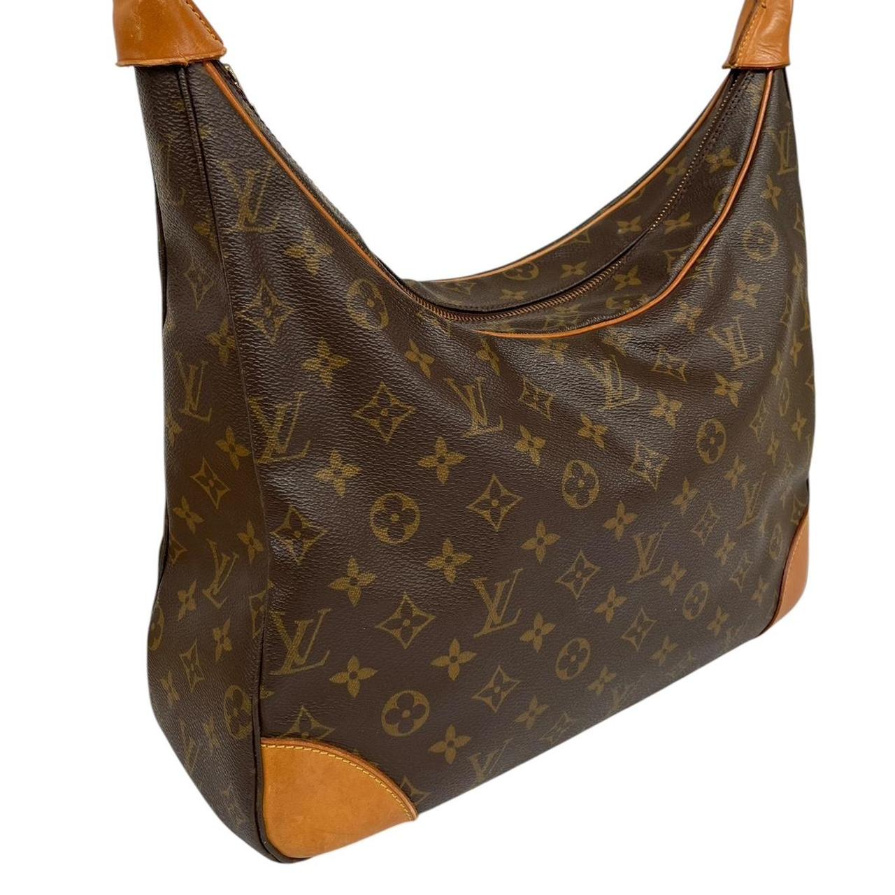 Louis Vuitton brown and tan monogram canvas duffel bag with leather accents and logo.