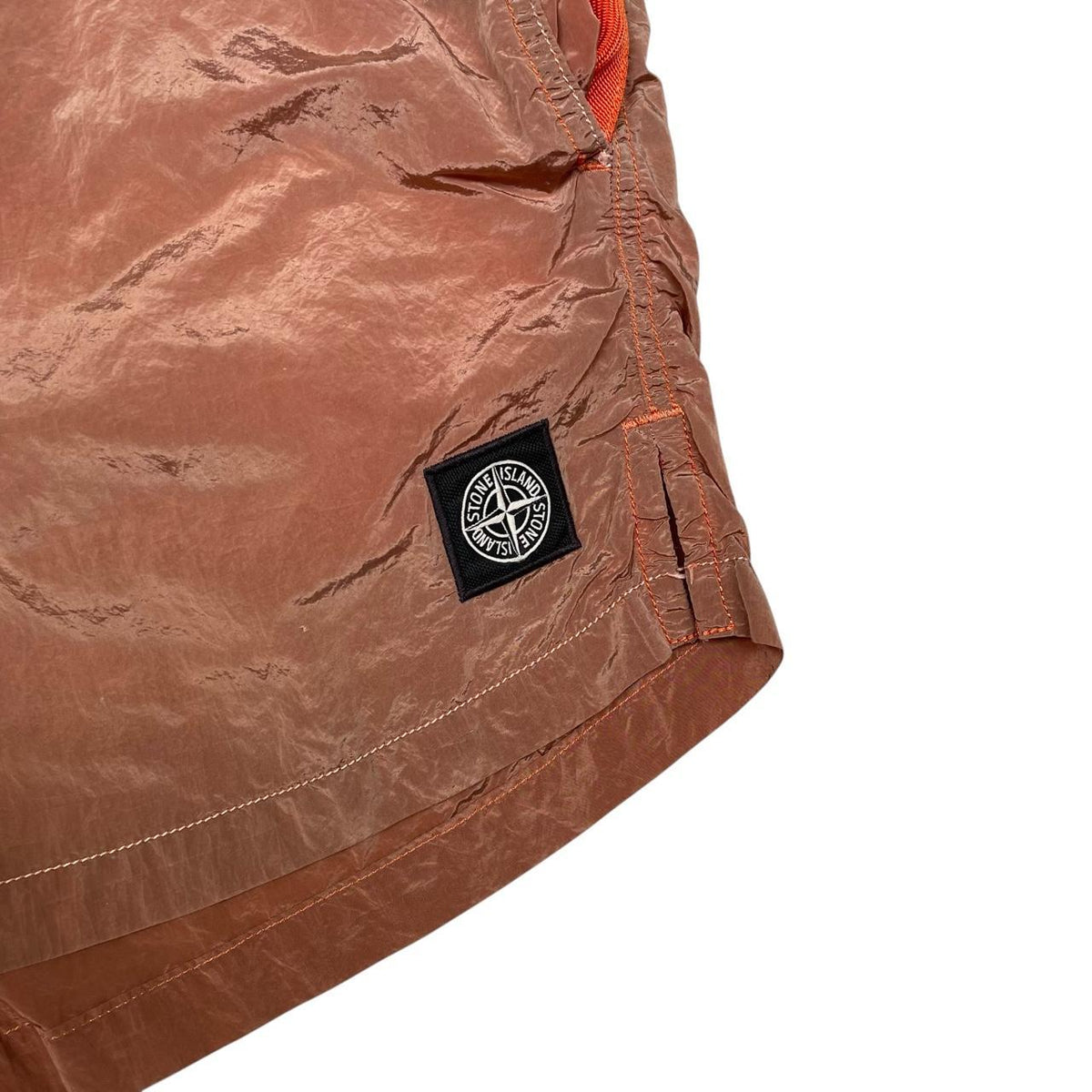 Stone Island orange swim shorts with logo patch and nylon metal material.