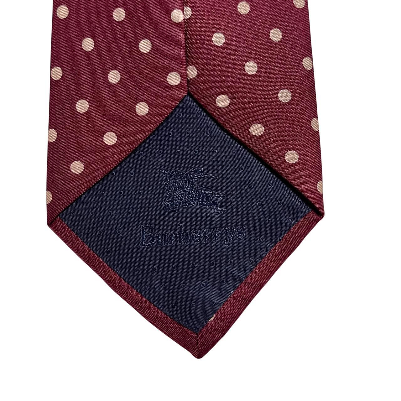 Burberry burgundy silk tie with white polka dots and classic logo detail.
