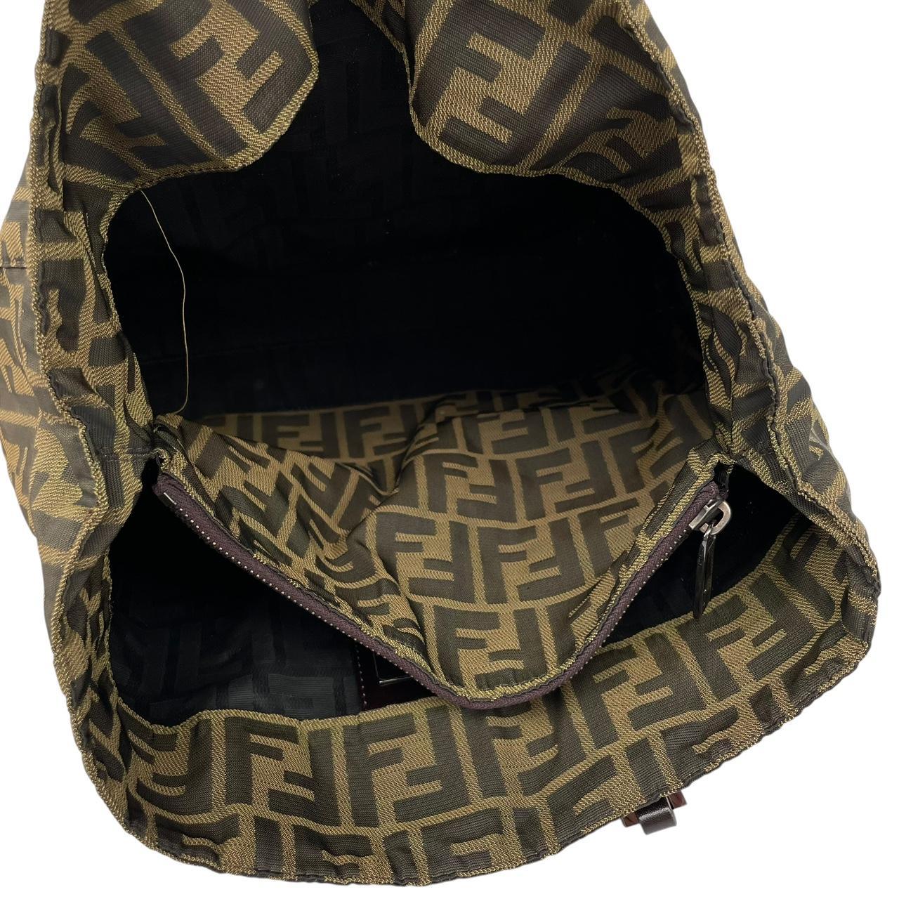 Fendi brown duffel bag featuring iconic Zucca monogram canvas and leather handles.