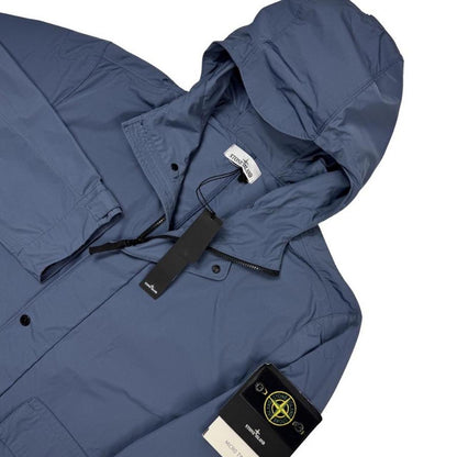 Stone Island blue hooded jacket with logo patch and micro twill fabric.