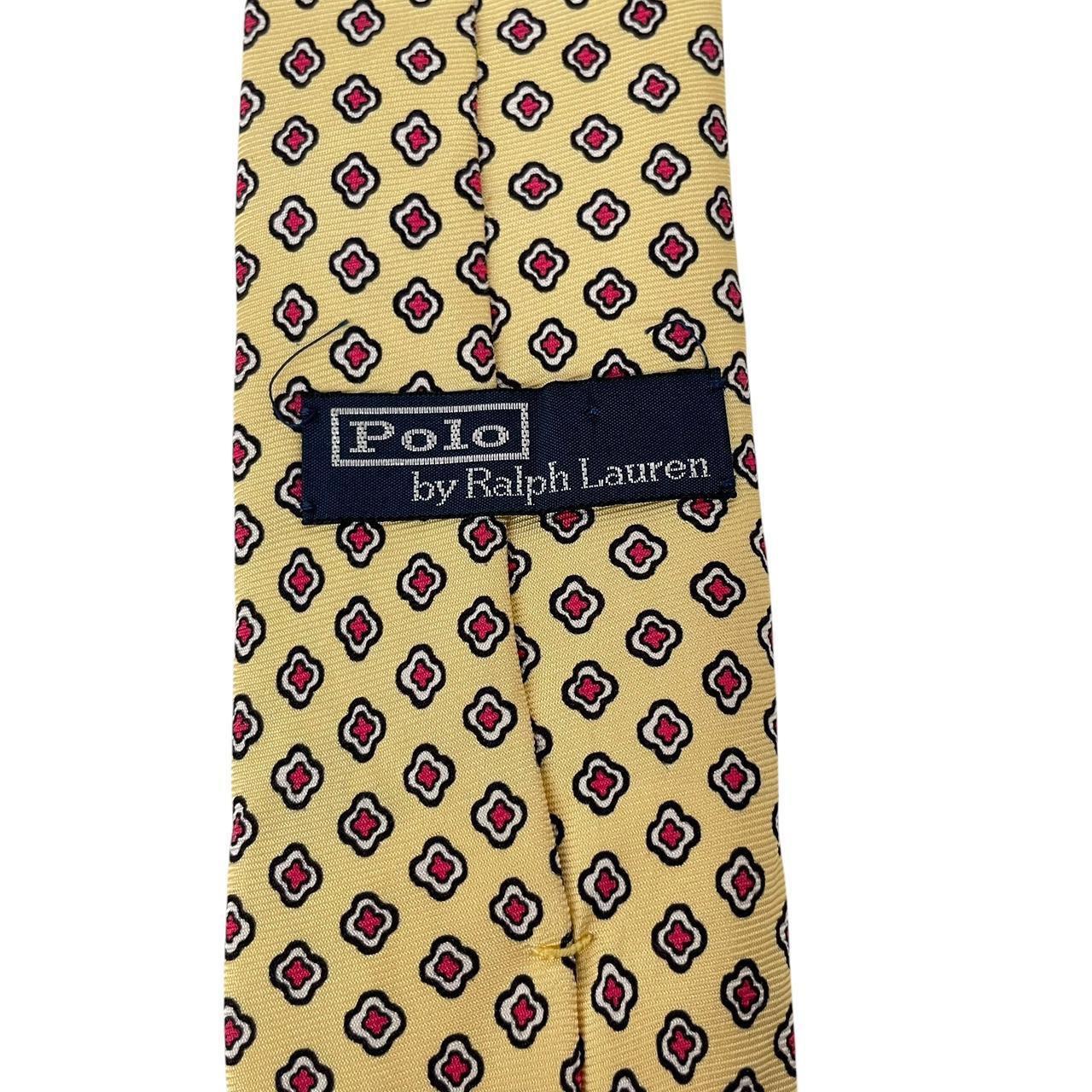 Polo Ralph Lauren yellow silk tie with geometric print design and logo detail.