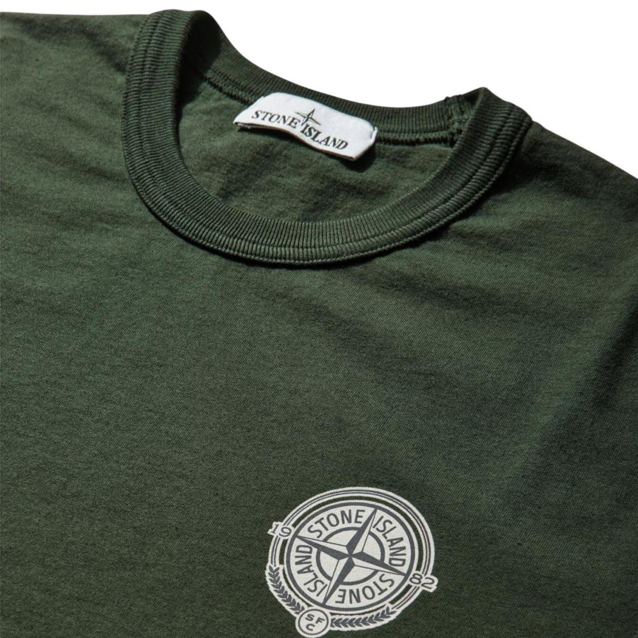 Stone Island green pocket t-shirt with embroidered crest and New Balance logo.