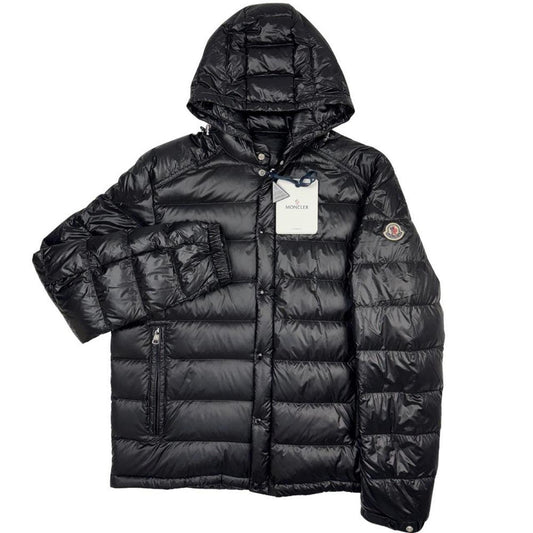 Moncler black hooded puffer jacket with logo patch and nylon material.