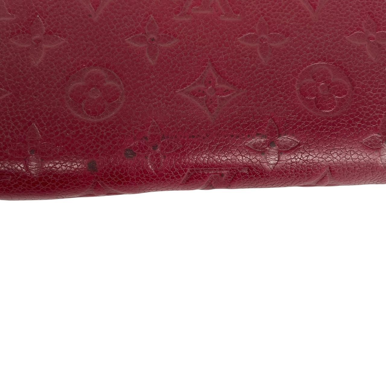 Louis Vuitton black leather wallet with monogram pattern and embossed logo.