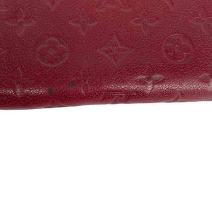 Louis Vuitton black leather wallet with monogram pattern and embossed logo.